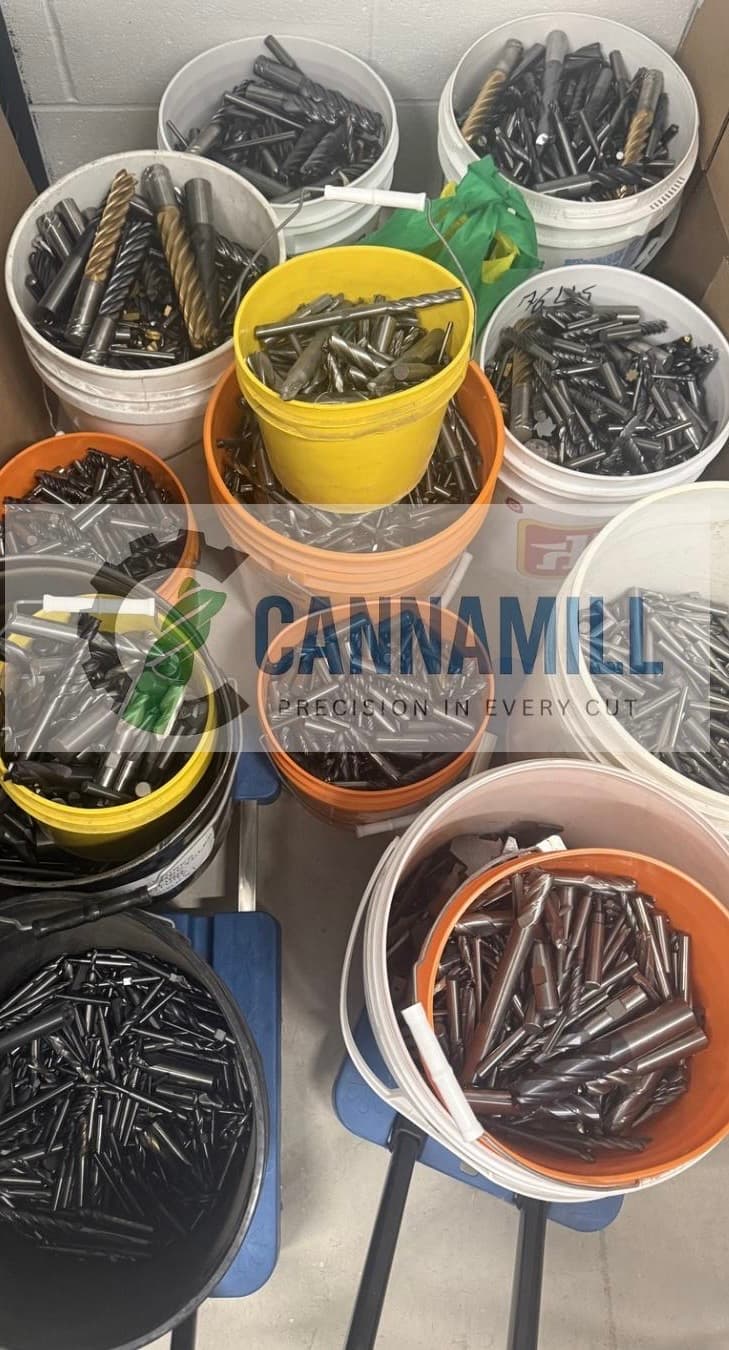 Warehouse sorting and collection area showing buckets of carbide scrap tooling